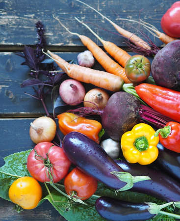 Agricultural background. Heap of fresh vegetables on a rustic wooden dark background.の写真素材