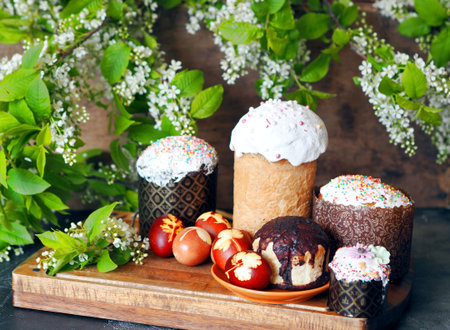 Homemade Easter buns with traditional eggs on a kitchen board. Easter preparation. Healthy natural...