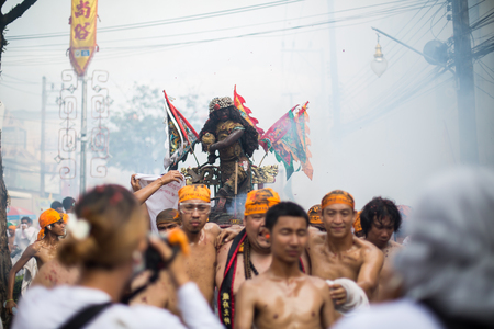 PHUKET, THAILAND - SEPTEMBER 30:Taoist devotees participate in a street procession of the Nine Emperor Gods Festival, known locally as the Phuket Vegetarian Festival on the 30th September, 2014. in Phuket Town, Phuket, Thailand.のeditorial素材