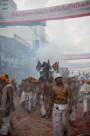 PHUKET, THAILAND - SEPTEMBER 30:Taoist devotees participate in a street procession of the Nine Emperor Gods Festival, known locally as the Phuket Vegetarian Festival on the 30th September, 2014. in Phuket Town, Phuket, Thailand.のeditorial素材