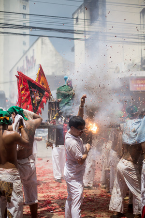 PHUKET, THAILAND - SEPTEMBER 30:Taoist devotees participate in a street procession of the Nine Emperor Gods Festival, known locally as the Phuket Vegetarian Festival on the 30th September, 2014. in Phuket Town, Phuket, Thailand.のeditorial素材