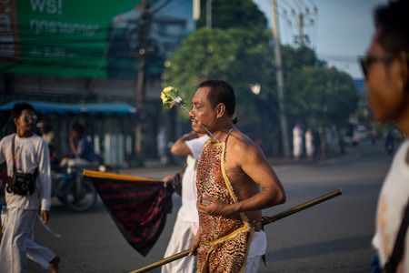 PHUKET, THAILAND ? October 1: Unidentified Mah song pierced weapon to their cheeks, They believed to suffer the pain of devotee during the Phuket Vegetarian Festival. The Festival is a famous annual festival also known as Nine Emperor Gods festival on theのeditorial素材