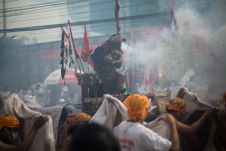 PHUKET, THAILAND - SEPTEMBER 30:Taoist devotees participate in a street procession of the Nine Emperor Gods Festival, known locally as the Phuket Vegetarian Festival on the 30th September, 2014. in Phuket Town, Phuket, Thailand.のeditorial素材