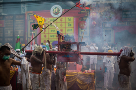 PHUKET, THAILAND - SEPTEMBER 30:Taoist devotees participate in a street procession of the Nine Emperor Gods Festival, known locally as the Phuket Vegetarian Festival on the 30th September, 2014. in Phuket Town, Phuket, Thailand.のeditorial素材
