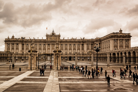 Madrid's royal palace. Spain, Europe Cloudy sky in spring. Tourists visiting the palace, people walking the streets.のeditorial素材