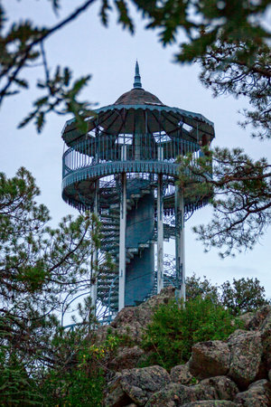 Romantic stairs with beautiful views. Eiffel architect watchtower in Avila. Blue sunset with pines...