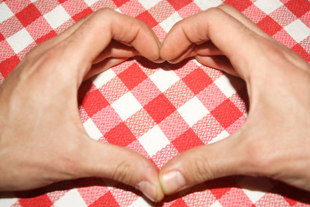 Declaration of love on Valentine's Day. Detail photography, gesture with the hands forming a heartの写真素材