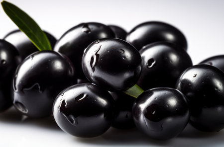 Black olives on a white acrylic background. close-up.の素材