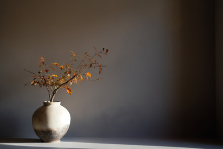 Vase with dry leaves on the background of the wall in the roomの素材