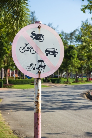 Rusty old road sign denoting no through road for motorcycles, tuk tuk, car, bicycleの写真素材