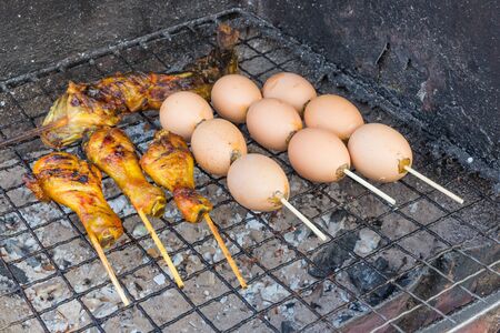 Grilling chicken and egg leg on the stoveの写真素材