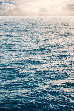 Peaceful image of calm sea and cloudy sky in the background の写真素材