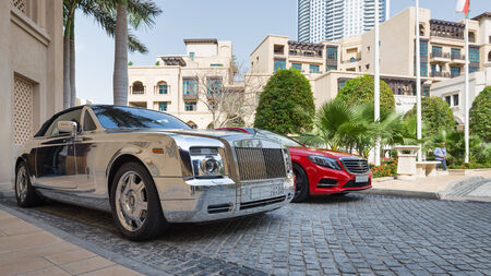 DUBAI, UAE - MARCH 30, 2014  Luxury car parked outside Palace Hotel のeditorial素材