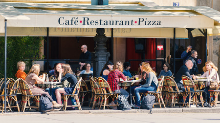 PARIS, FRANCE - MAY 16, 2014: Tourists sit in a traditional Parisian cafe. There are about 40,000 restaurants in Paris.のeditorial素材