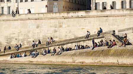 PARIS, FRANCE - MAY 16, 2014: People relax on the river Seine at sunset.のeditorial素材