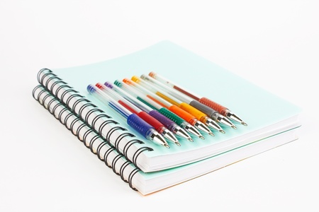  notebooks and pens on a white background の写真素材