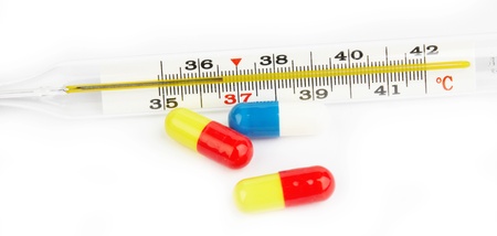 colorful pills and pharmacy thermometer on whiteの写真素材