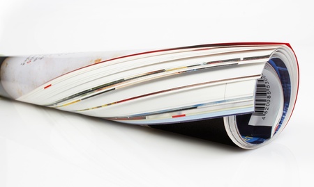 Roll of newspaper on white background の写真素材
