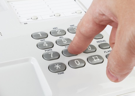 white phone with hand on white background の写真素材