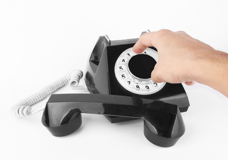 black old phone with hand on white background の写真素材