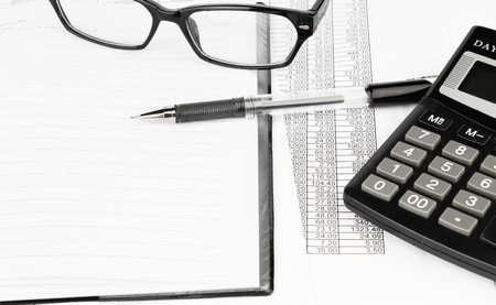 calculator and pen on a business background の写真素材