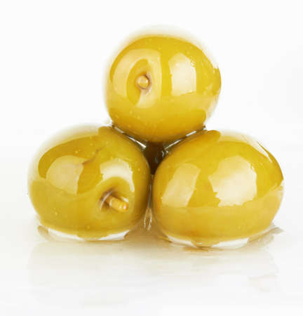 green olives on a white background  の写真素材
