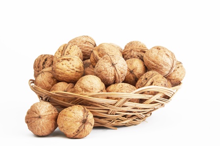 walnuts in a basket on a white backgroundの写真素材