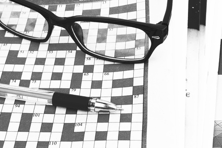 pen lying on a blank crossword to be filled の写真素材