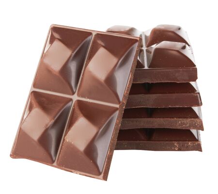 Stacked dark chocolate isolated on a white の写真素材
