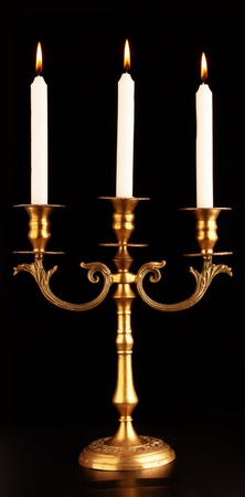 Old-fashioned baroque elegant candlestick on a black background の写真素材