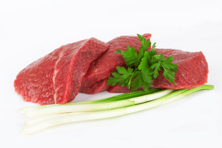 raw meat and vegetables on white