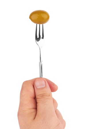 Olive on a fork in the hand on a whiteの写真素材