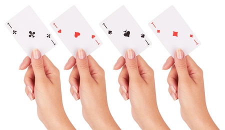Playing card in hand isolated on white background の写真素材