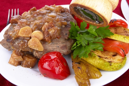 Grilled steak meat with vegetables on a white backgroundの写真素材