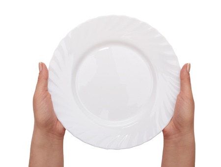 white kitchen plate on woman hand on white backgroundの写真素材