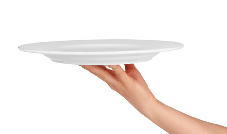 white kitchen plate on woman hand on white background の写真素材