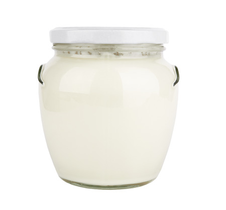 glass jar with a lid with liquid on a white backgroundの写真素材