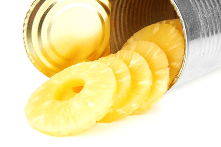 Portion of canned sliced pineapple isolated on white background の写真素材