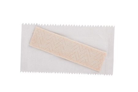 Chewing gum plate on wrapping paper isolated on whiteの写真素材