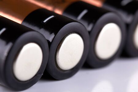 four orange alkaline batteries macro on whiteの写真素材