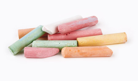 broken pieces of colored chalk isolated on white backgroundの写真素材