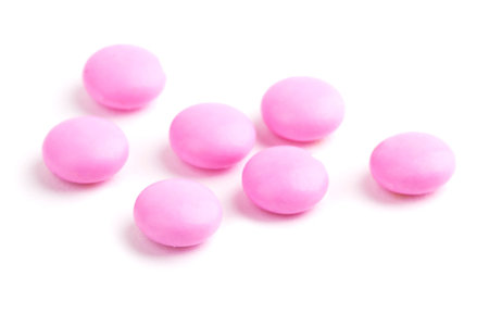 Pink pills isolated on a white backgroundの写真素材
