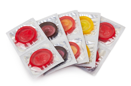 Colorful condoms isolated on white backgroundの写真素材