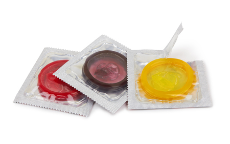 Colorful condoms isolated on white backgroundの写真素材