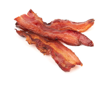 cooked slices of bacon isolated on white background