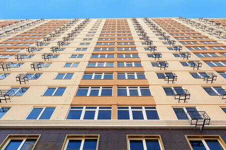view from below at yellow apartment buildingの写真素材