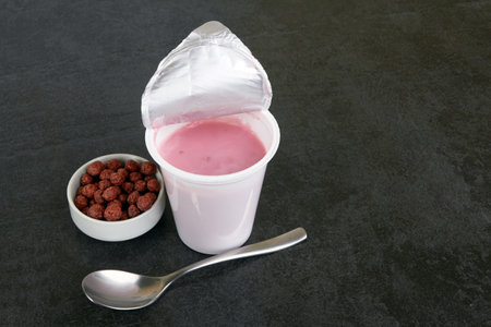 Fruit yogurt on a dark stone surfaceの写真素材