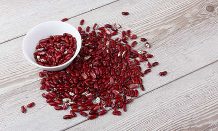 Red beans isolated on a wooden backgroundの写真素材