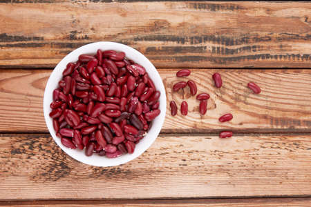Red beans isolated on a wooden backgroundの写真素材