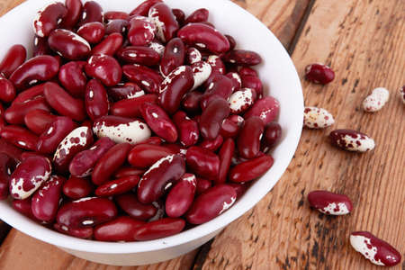 Red beans isolated on a wooden backgroundの写真素材